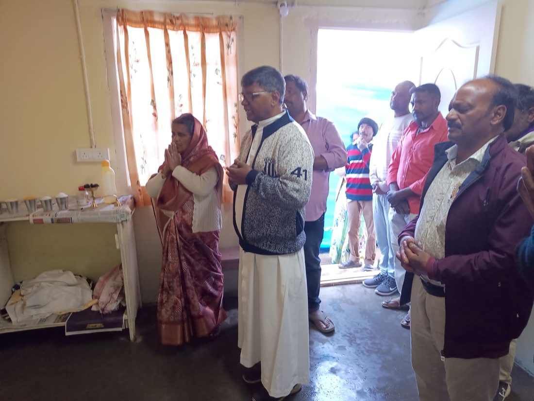 Blessing the finished house with the family and neighbours.