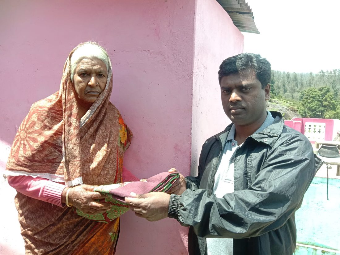 A blanket handed over, house to house, before the cold set in.