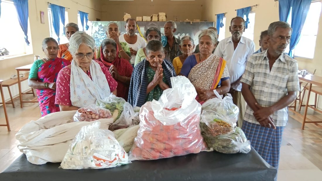Prayer with families and volunteers before a distribution